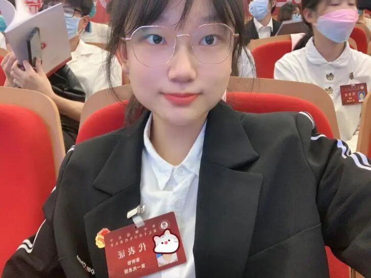 Xinyi Zhang attending a formal conference