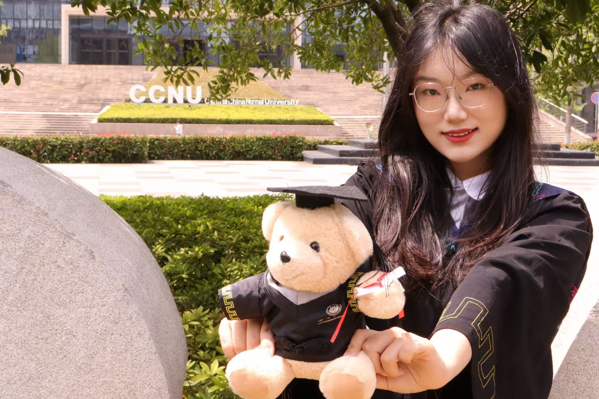 Xinyi Zhang at Central China Normal University with a graduation bear